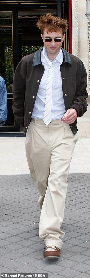 The Mickey 17 actor added cream trousers and a dark brown jacket to his ensembles, smiling at fans as he walked