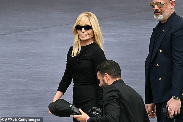 Dontella oozed confidence as she donned a sleek black midi dress and shades for the show