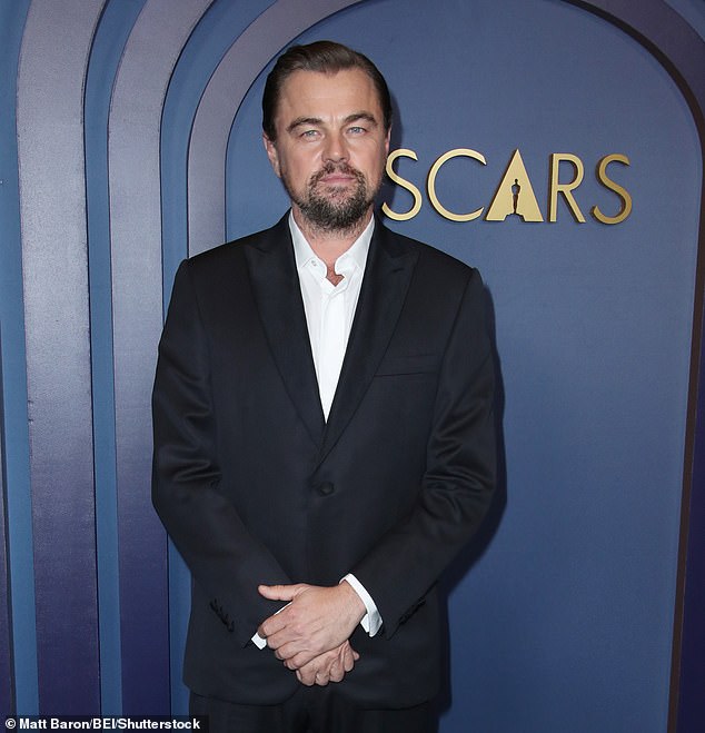 The Oscar winner, 50, is known for his trademark baseball cap but took the look to a new extreme at the wedding festivities as he pulled the hat comically down over his eyes while stepping out - pictured hatless in 2024