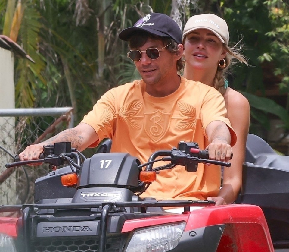 Louis Tomlinson and Zara McDermott riding an ATV.