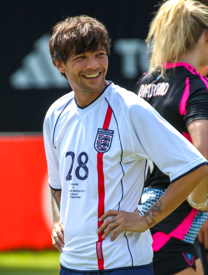 Louis Tomlinson in an England soccer jersey.