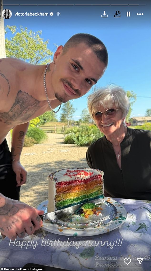 The famous footballer, 50, who was still sporting his arm in a sling, beamed in sun-soaked snaps as they marked the occasion with a huge colourful cake (Son Romeo pictured)