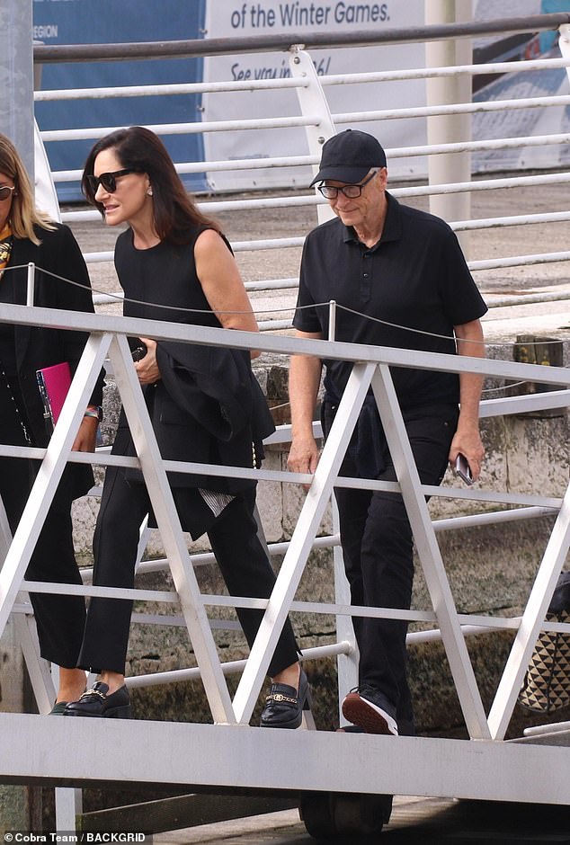The Microsoft founder and billionaire kept comfortable in a simple black polo neck and trousers with a matching baseball cap