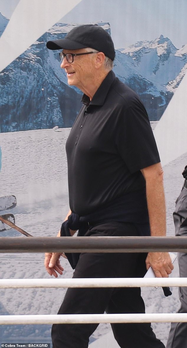 The Microsoft founder and billionaire kept comfortable in a simple black polo neck and trousers with a matching baseball cap