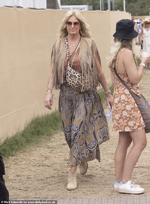 The matriarch, 54, looked very bohemian as she wore a tassel coat, oversized sunglasses, balloon trousers and a leopard print bag
