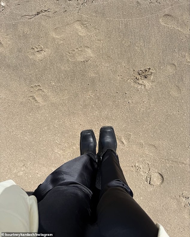 She also posted a snapshot of her legs as she stood on the beach. She sported satin pants with square-toed boots as she stood in the sand