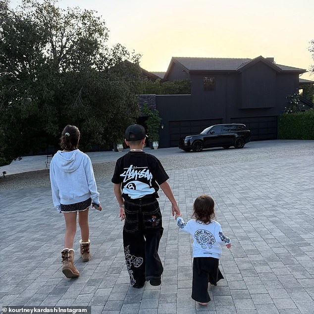 She also included a photo of her youngest three kids walking together on a stroll through their gated neighborhood in Calabasas. In a photo of her children facing away from her, her daughter Penelope could be seen walking alongside her sons Reign and Rocky, who were sweetly holding hands