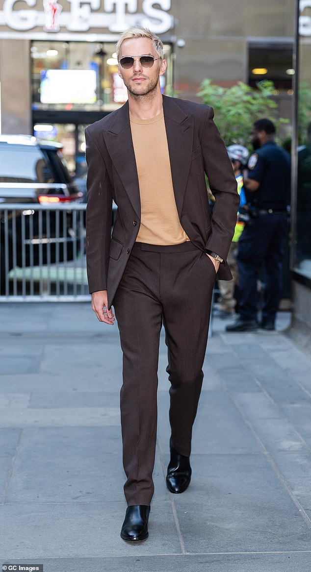 Nicholas was first seen walking around Midtown looking dapper in a brown tailored suit and a tan sweater underneath