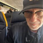An 80s pop icon who penned a classic Christmas song looked totally unrecognisable as he was pictured hopping on a Ryanair flight this week