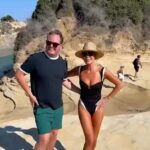 Amanda Holden showcased her sensational figure in a plunging swimsuit on Sunday as she enjoyed her time in Greece with Alan Carr