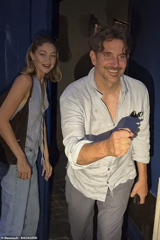 Gigi Hadid and Bradley Cooper were all smiles as they stopped for fans on their way home after a night out in Paris on Saturday