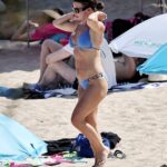Coleen Rooney showed off her toned figure in a blue bikini as she soaked up the sun in Ibiza on Friday with her husband Wayne