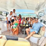 Coleen and Wayne Rooney looked smitten as they joined former footballer John O'Shea (far right) on a sun-soaked boat trip in Ibiza on Wednesday