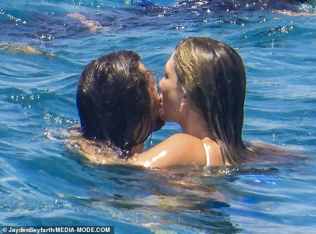 Delta was seen laughing and jumping into the water with her husband before the pair embraced in a cheeky kiss on the cheek while cooling off in the Mediterranean