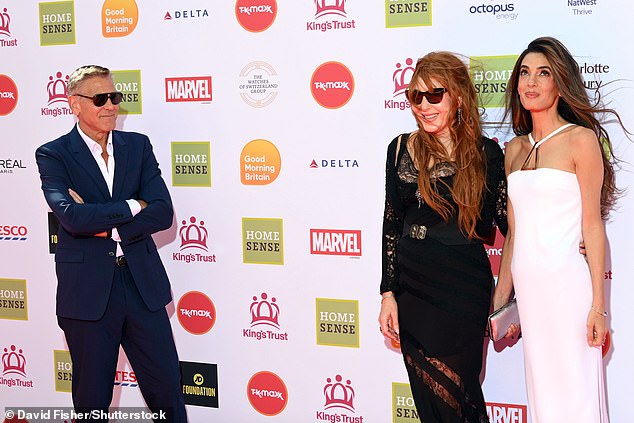 George Clooney proved he is ever the gentleman as he let his glamorous wife Amal take centre stage on the red carpet at the King's Trust Awards in London on Thursday; pictured with Charlotte Tilbury