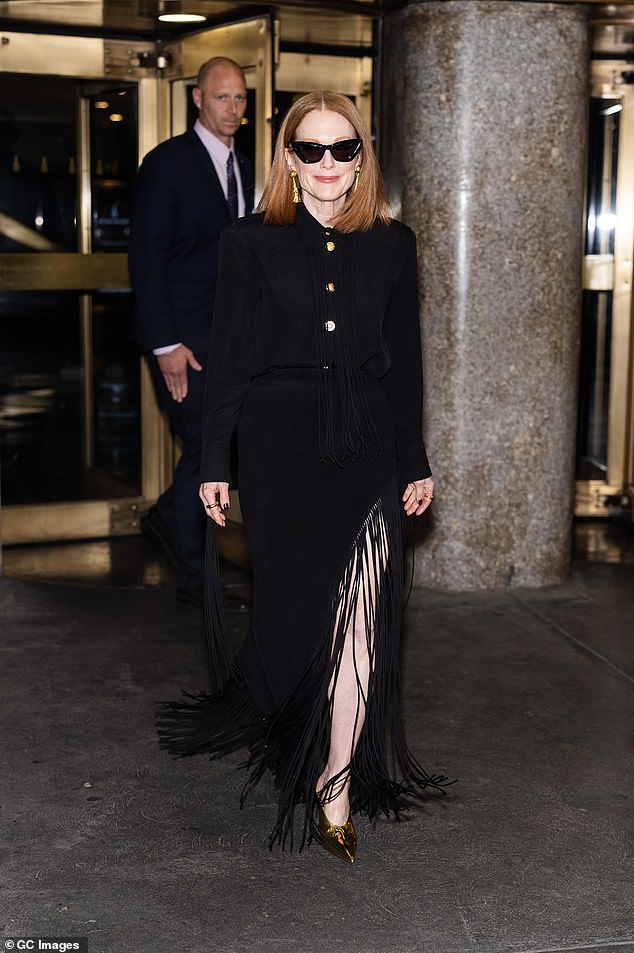 Julianne Moore, 64, put on a leggy display in a black fringed dress as she stepped out in New York on Thursday