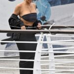 Kim Kardashian ensured she would turn heads as she arrived at her Venice hotel in a tiny ab-flashing bandeau top on Thursday ahead of Jeff Bezos and Lauren Sanchez's wedding