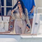 Kim Kardashian showcased her tiny waist in skintight cropped bottoms for a luxe yacht trip with daughter North in Los Cabos