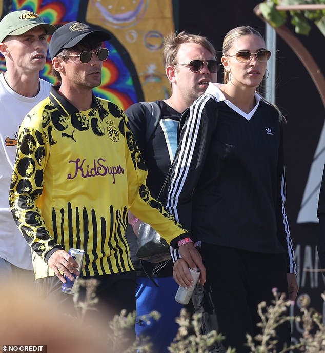 The One Direction singer and Love Island star cut low key figures as they were spotted soaking up the Somerset sun at the iconic music event