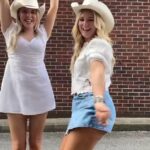 Diddly Squat farmhand Harriet Cowan (right) danced in a denim skirt and cowboy boots as she head out to a country day on Sunday