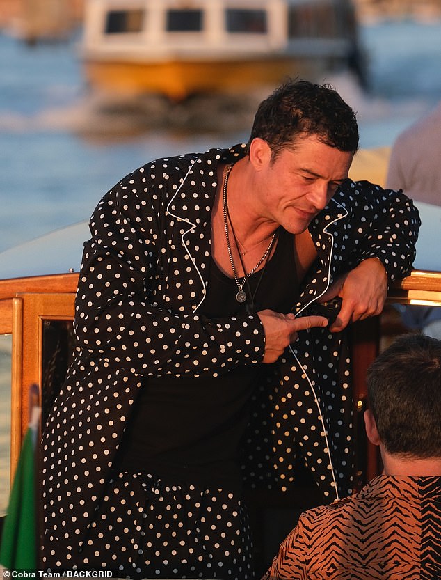 As he prepared to attend the Bezos' post-nuptials soirée, he was seen basking in the golden hour rays and lounging in polkadot pajamas