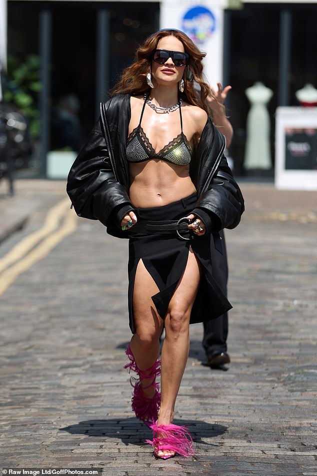 Rita Ora, 34, flashed her abs in a tiny bralette as she made her third outfit change all in one day in London on Friday