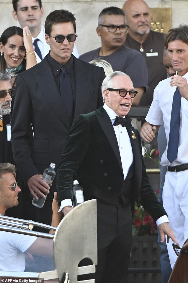 In the video, he is seen walking ahead of quarterback Tom Brady — who risked an awkward run-in with his former flame at what has been widely dubbed as the 'wedding of the century'