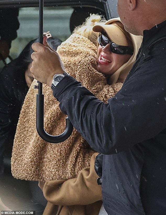The 40-year-old clung to her daughter, Daisy Dove, four, who she shares with her former fiancé Orlando, 48