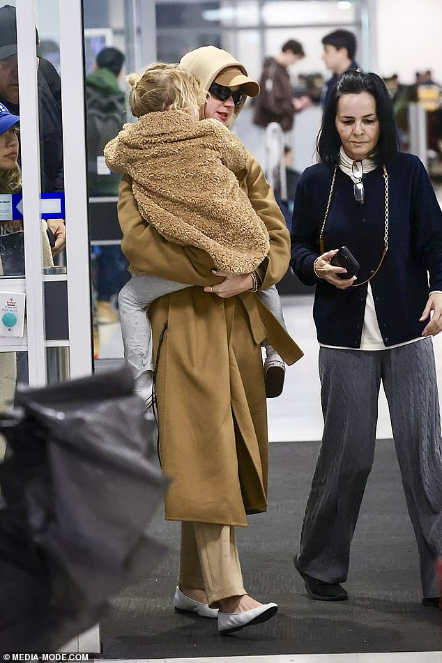 The singer was dressed for Sydney's incredibly chilly winter weather in a camel toned coat paired with a cap in a similar beige tone