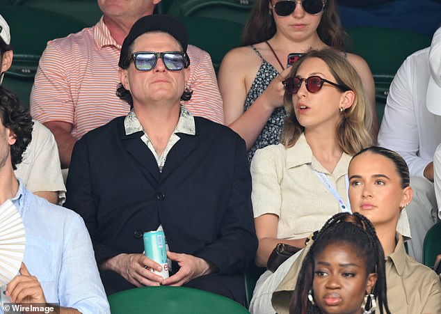 They both donned shades to watch the match