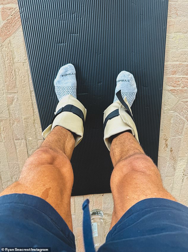 A POV image showed off Ryan's muscular legs as he stood on a yoga mat