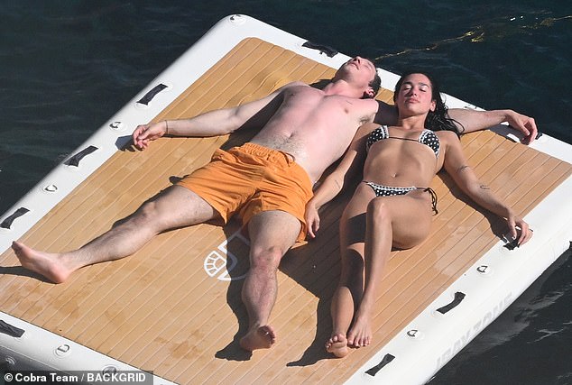 The singer, 29, and the actor, 35, couldn't keep their hands off each other as they shared a passionate kiss while sunbathing