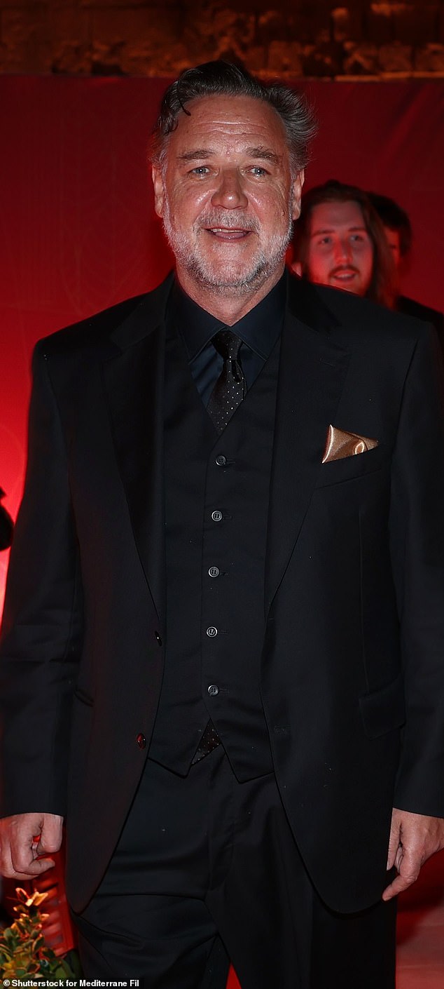 Russell turned more than a few heads, looking trim and terrific in an all-black look that consisted of an immaculately tailored suit paired with a crisp black dress shirt and vest