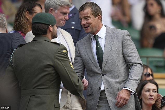Bear was seen shaking hands with a member of the armed forces as he mingled in the Royal Box before taking his seat