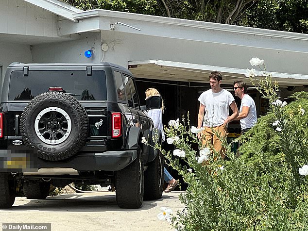 A brunette man, who looked to be Madsen's son Max, 31, appeared to console DeAnna as she leaned in close to him