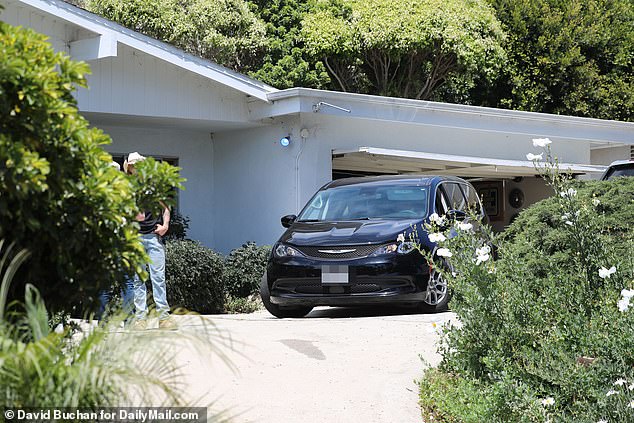 A black Chrysler vehicle, seemingly belonging to the coroner, was also parked in Madsen's driveway