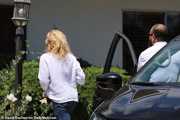 DeAnna, who Madsen accused of driving their son late Hudson to suicide, parked in the driveway and rushed to the front door