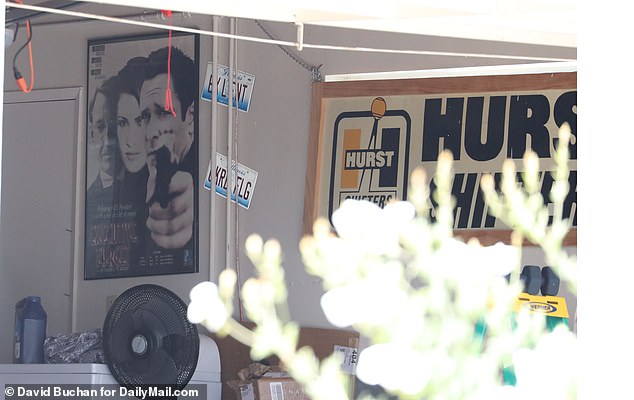 Madsen had a Hurst Shifters sign, dumbbell weights, old license plates and the poster for his 1997 film Executive Target displayed in his garage
