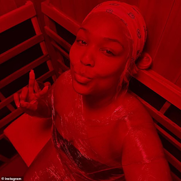 Lizzo flashed a peace sign while enjoying a red light sauna session