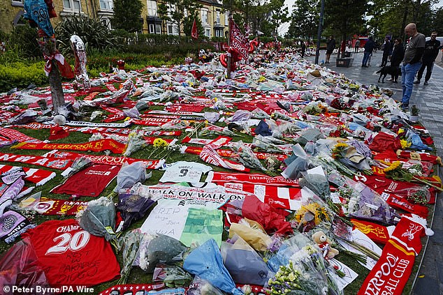 Hundreds of fans laid flowers and scarves outside Liverpool's home stadium on Thursday