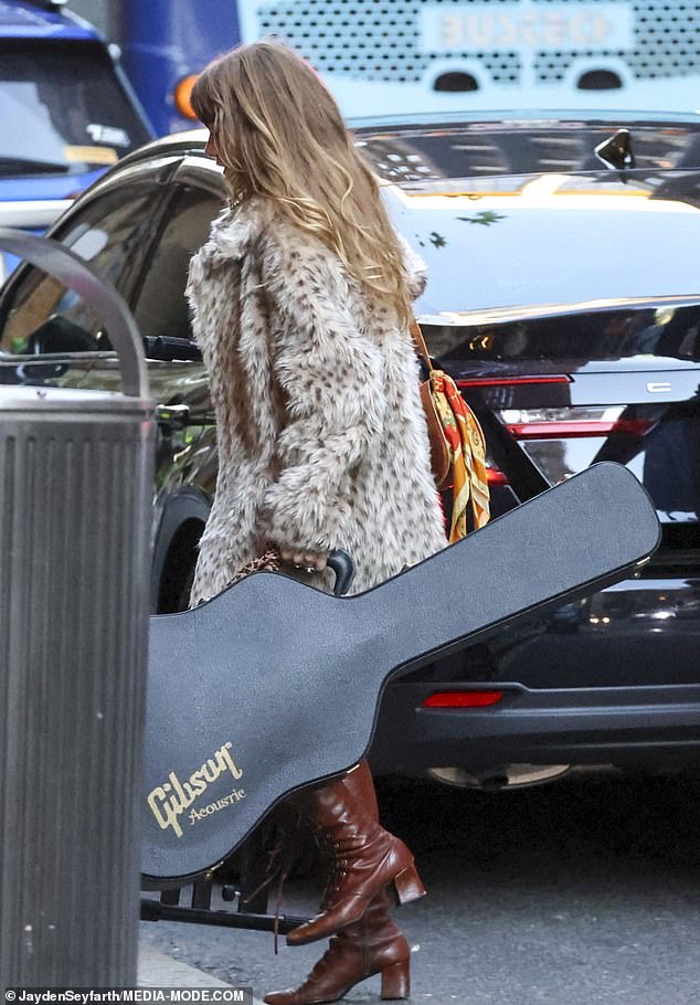 Arriving at the venue with a bandmate, Mia could be seen grabbing a large black guitar case from the trunk of her Uber