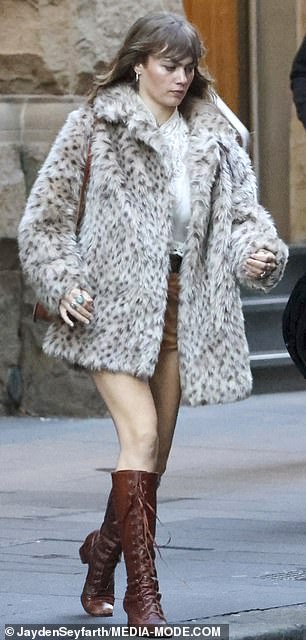 Mia rugged up against the inclement Sydney weather in a faux leopard print fur coat