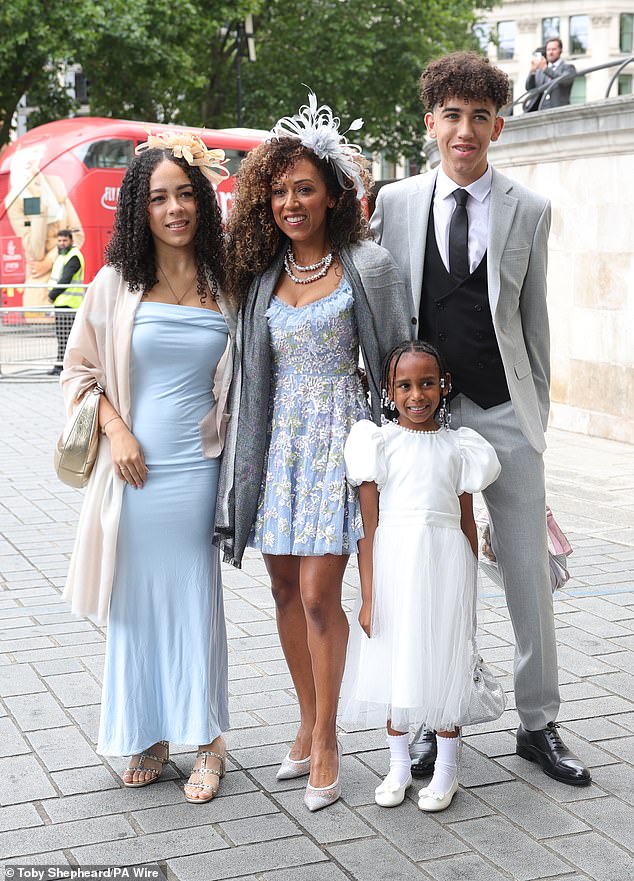 Danielle looked radiant in a blue floral mini dress as she headed into the cathedral with her children Mimi, Hendrix and Myla