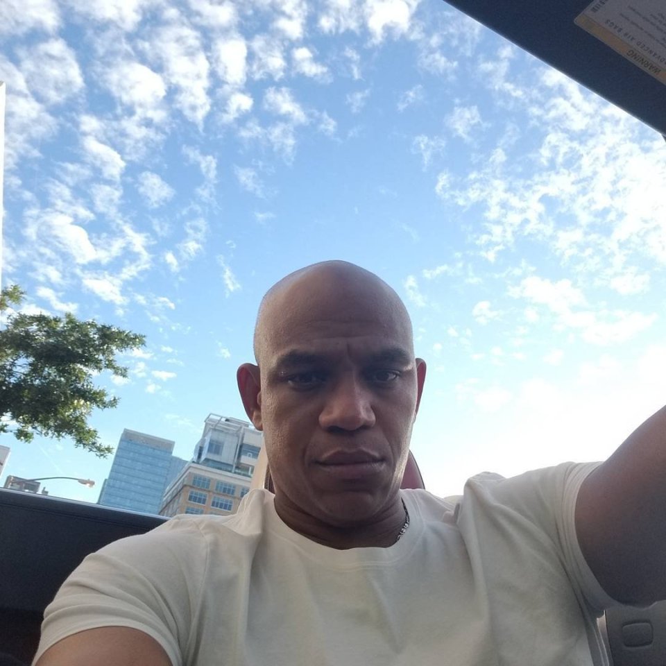 Sharay Hayes, aka The Punisher, in a convertible, looking at the camera.