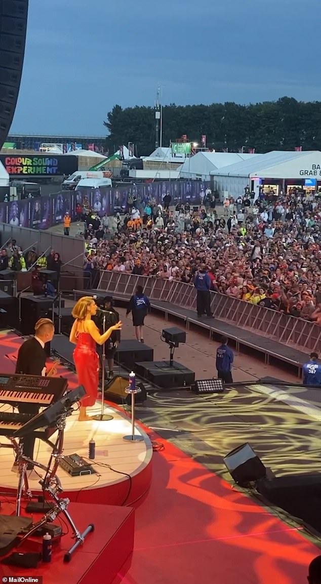 She looked sensational in a figure-hugging red leather gown, with Lewis barely able to take his eyes off her as he enjoyed the show