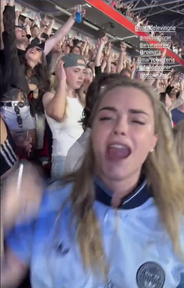 Anya Taylor-Joy and her model pal Cara Delevingne (seen) looked to be having the time of their lives as they belted out the band's hits from their seats