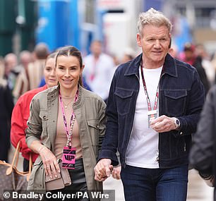 The couple were hand-in-hand and apparently nonplussed by the miserable weather while mingling with fellow spectators ahead of the spectacle