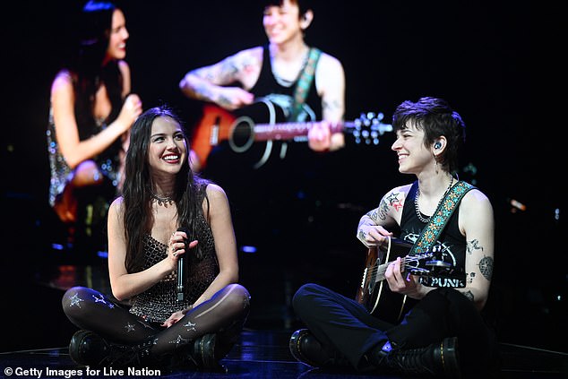 Daisy Spencer, 31, plays alongside fellow guitarist Emily Rosenfield, bassist Moa Munoz, drummer Hayley Brownell, and keyboardist Camila Mora on Olivia's GUTS tour (Seen in April)