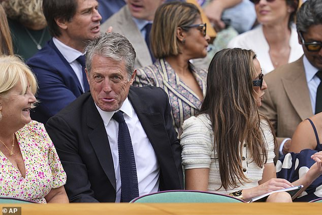 Hugh couldn't wipe the smile off his face as he chatted with guests next to him