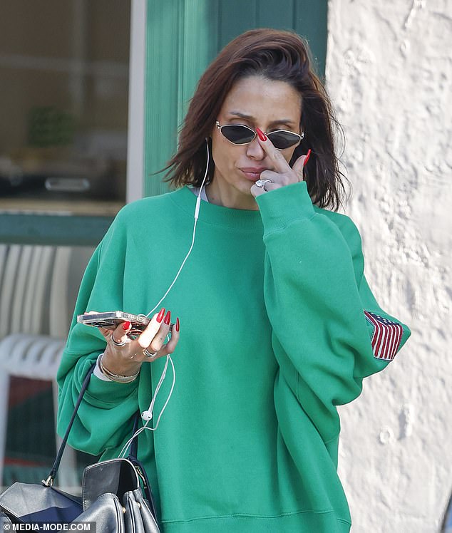She displayed her fresh long red nails as she left the shop after getting a manicure